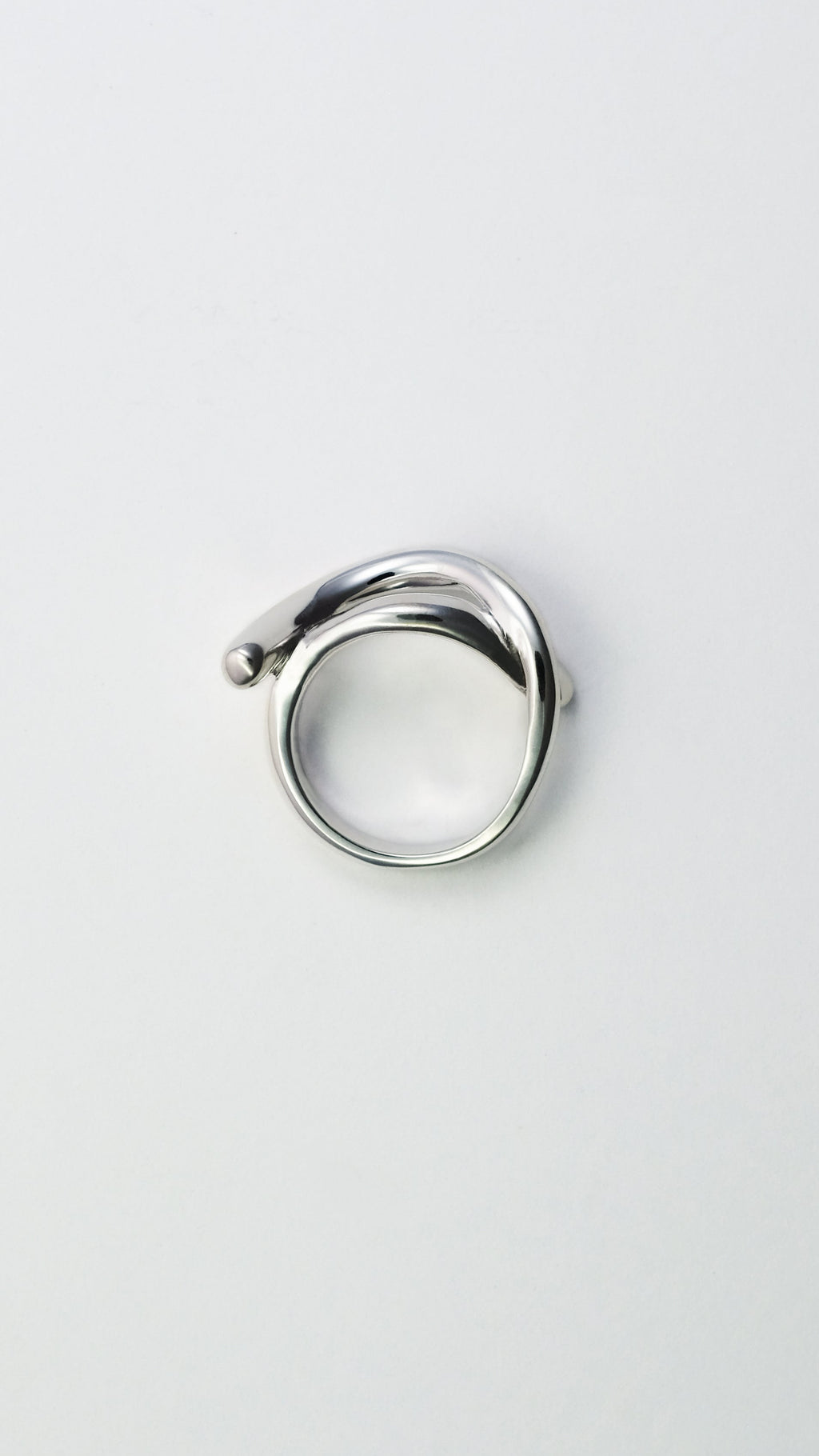 Silver ring on a light gray background