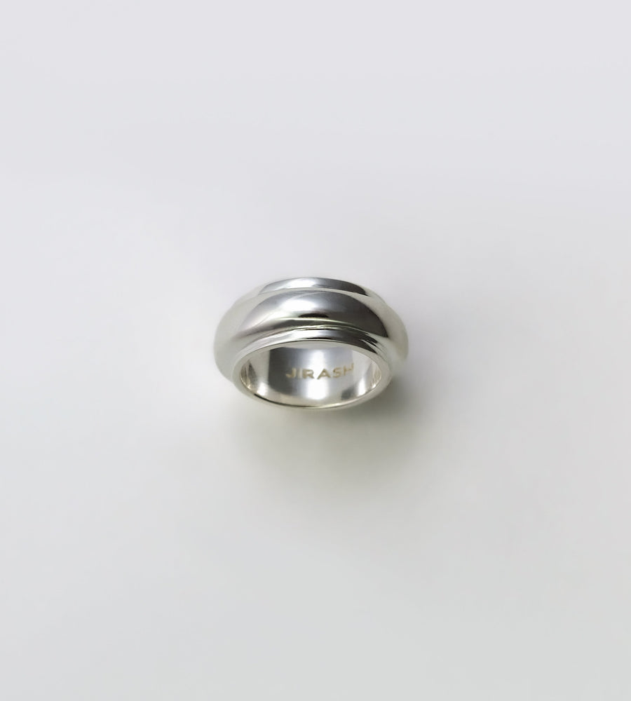 Silver ring on a light gray background