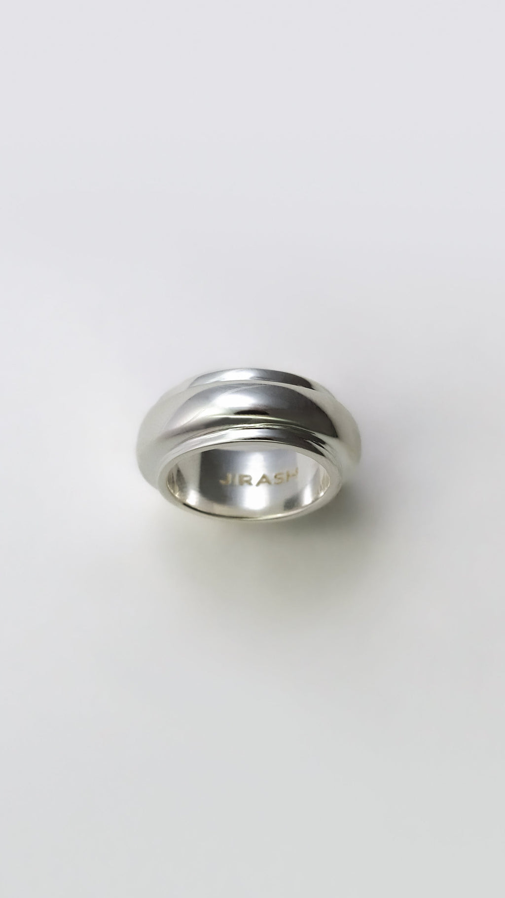 Silver ring with 'BRAC' branding on a white background