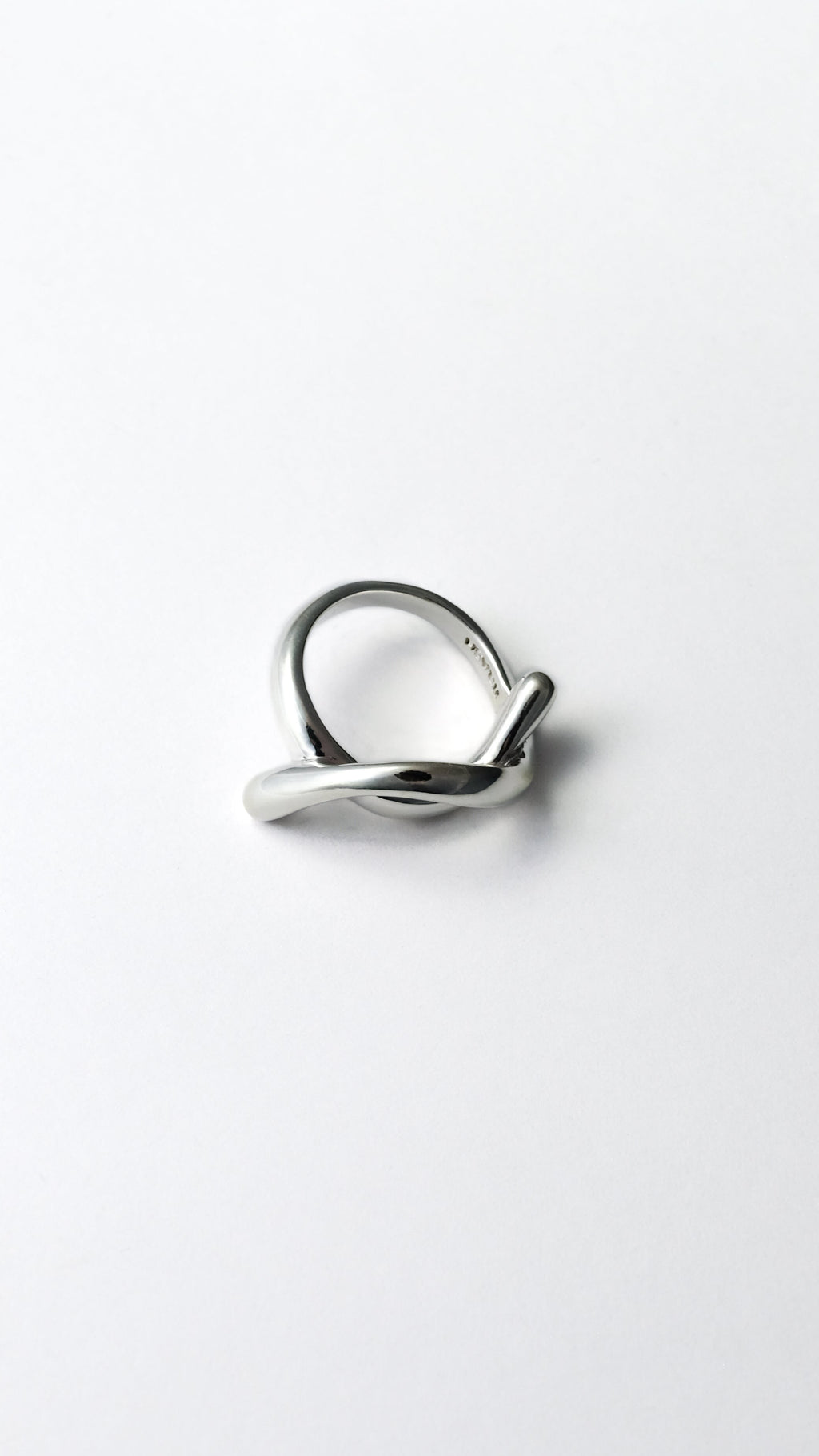 silver ring on a light gray background 