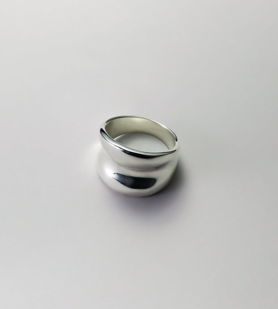 Silver ring on a light gray background