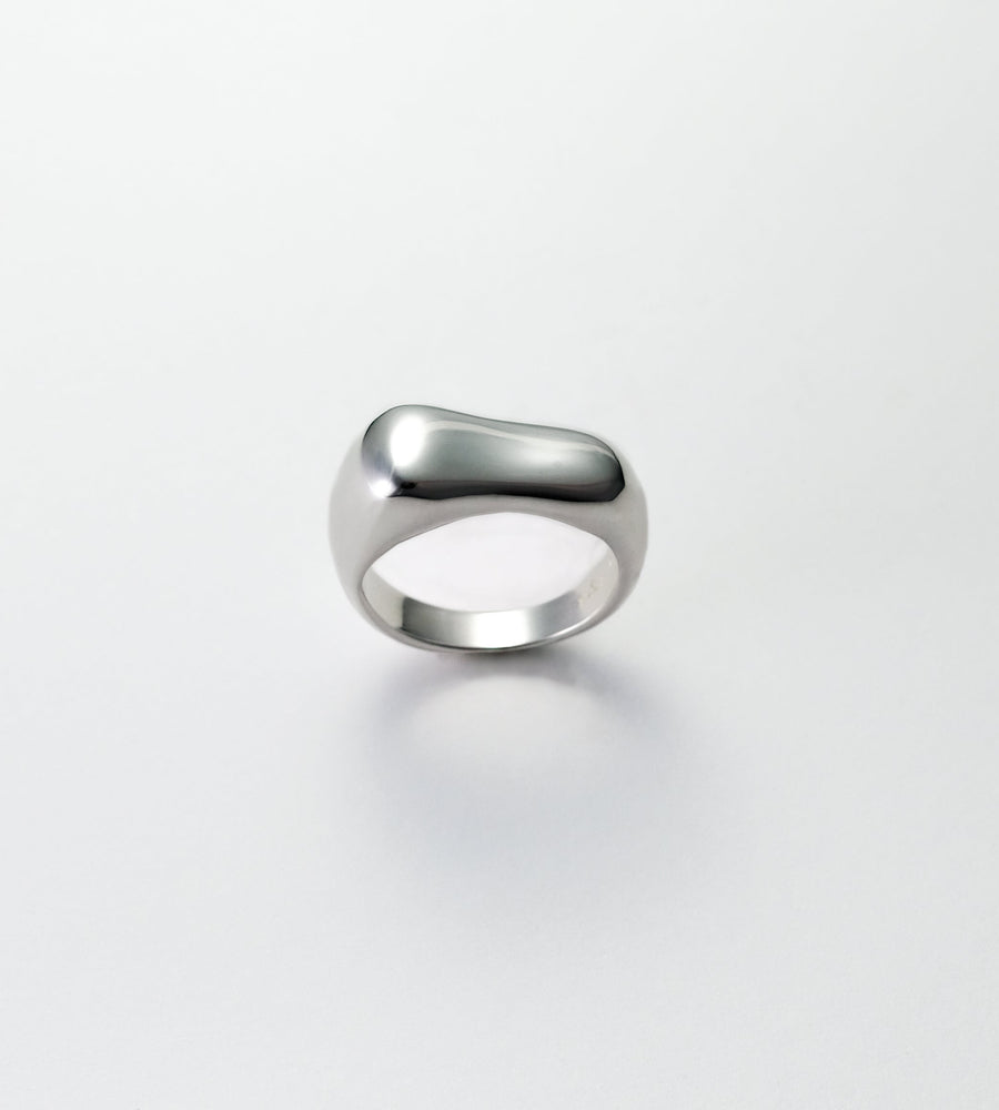 Silver ring on a light gray background