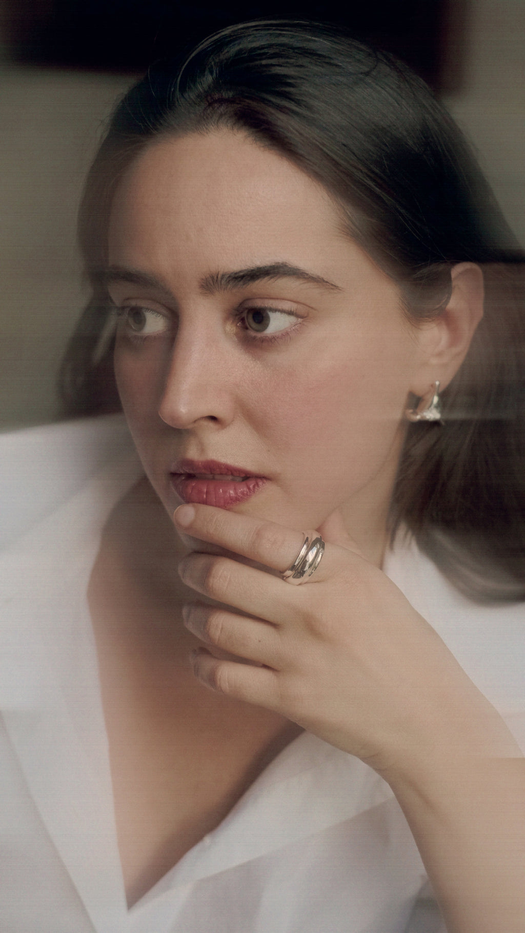 Woman wearing a ring with a white background