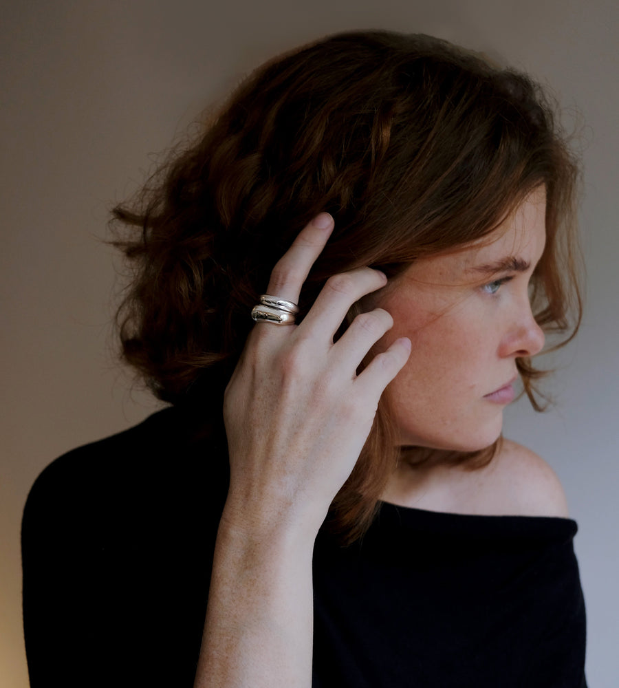 model wearing a silver ring stack 