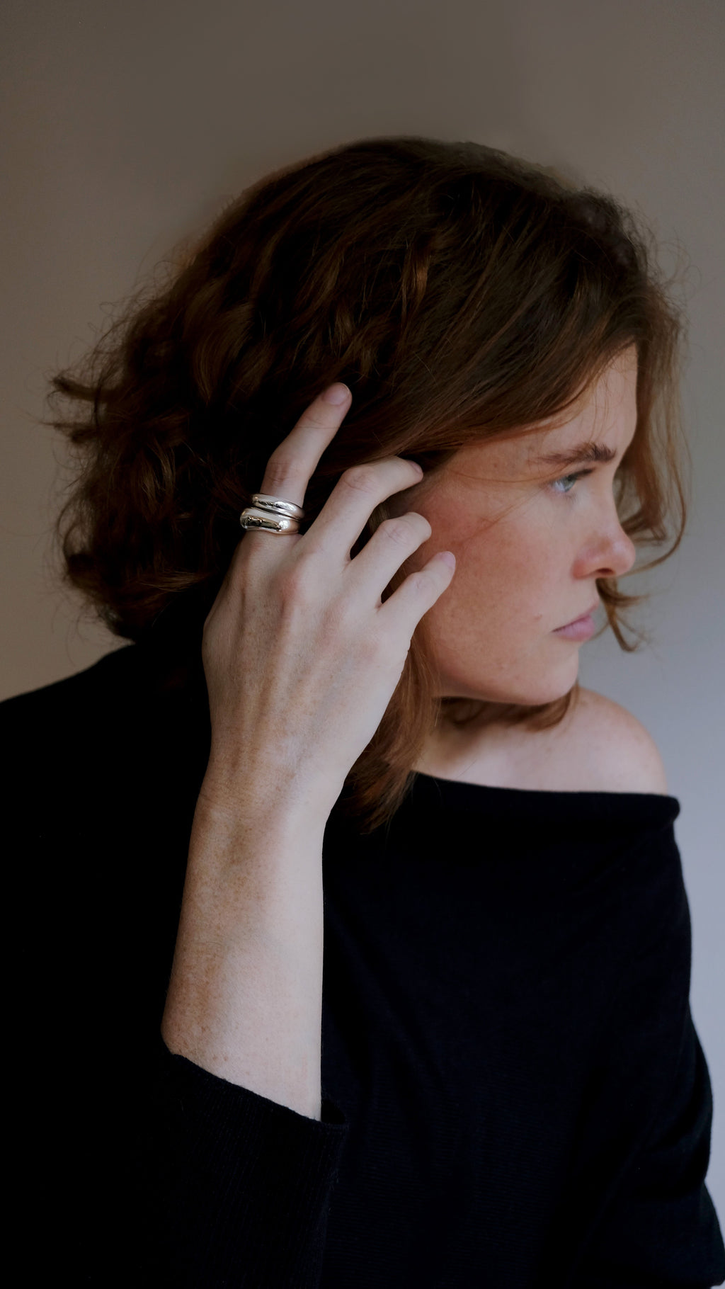 model wearing a silver ring stack