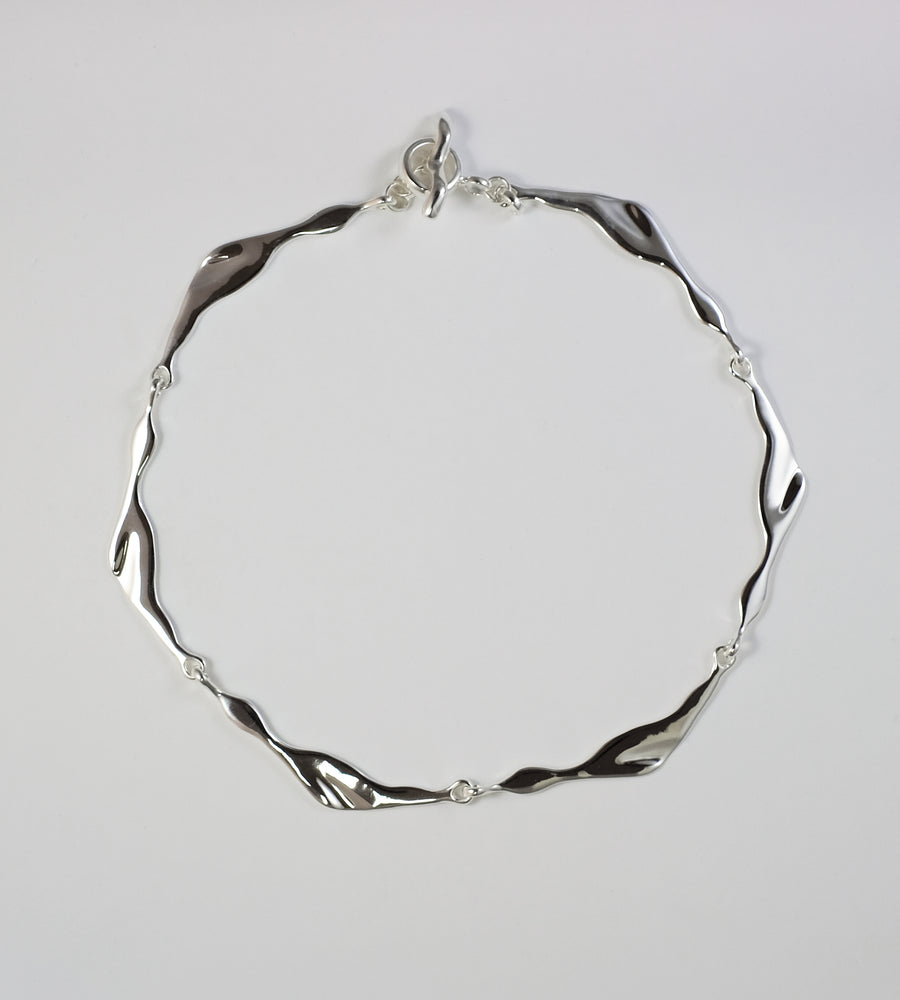 Sculptural sterling silver Necklace by Virginia Jirash. inspired by flight of birds.
Handmade in Mexico.